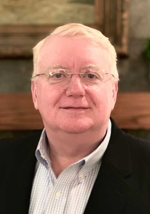 Headshot picture of Daryl Newman, CEO, wearing a black suit jacket and light colored shirt